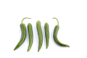 Some green chili peppers placed on a white background.