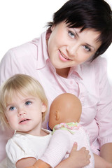 studio portrait of young attractive mother and daughter over whi