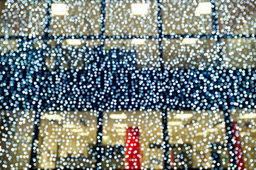 Blurred christmas decoration lights in front of glass building