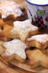 homemade gingerbread  star cookies with  kids milk on wooden tab