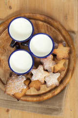 homemade gingerbread  star cookies with three kids milk on woode