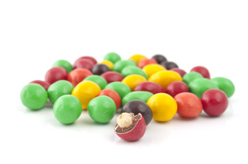 Pills with peanuts covered with multicolored glaze