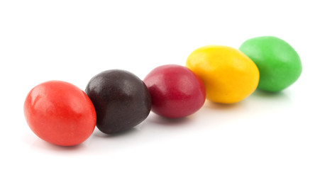 Pills with peanuts covered with multicolored glaze