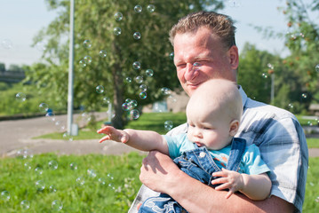 Dad and son look at the bubbles