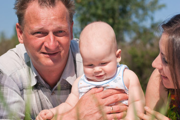 Fototapeta premium portrait of happy husband and wife with the baby
