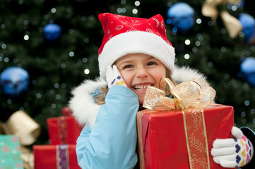 Fototapeta na wymiar Little girl with Christmas present