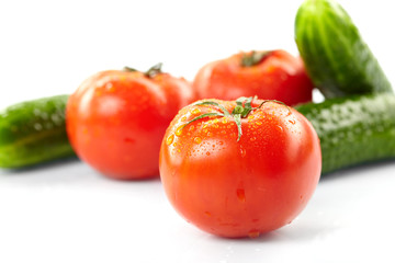 fresh tomatoes and cucumbers on the white background