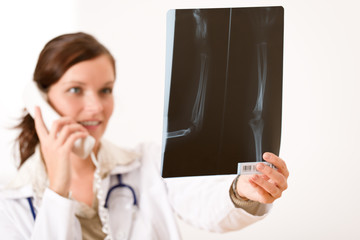 Female doctor with x-ray and phone