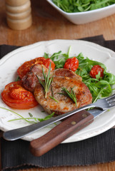 Pork fillet with rocket and cooked tomatoes