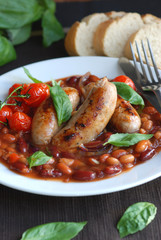 Sausages with mixed beans and tomatoes