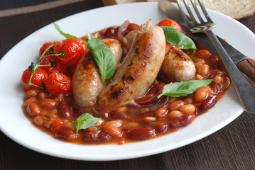 Sausages with mixed beans and tomatoes