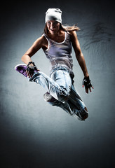 Fototapeta na wymiar Young woman dancer jumping