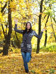 Beautiful woman spending time in park during autumn season