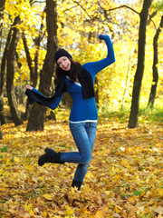 Beautiful woman spending time in park during autumn season