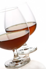 Glass of brandy over white background