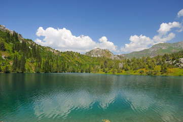 Colorful lake, mountains, sky and clouds