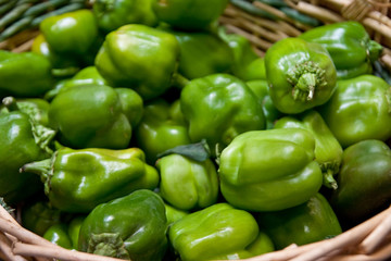 Obraz na płótnie Canvas Basket of Green Peppers in a Market