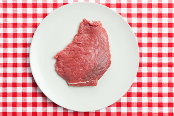 raw beef steak on plate