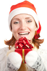 Happy smiling woman in christmas hat and mittens with gift