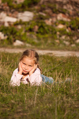 Fototapeta premium Beautiful girl lying on the grass