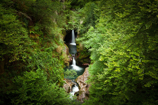 Waterfalls of Saja river in a will deep forest. Cantabria, Spain