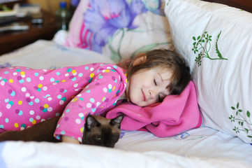 Girl and the cat in the bed