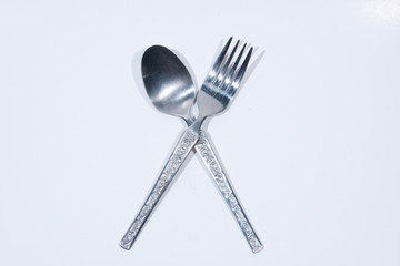 Spoon and fork on a white background.