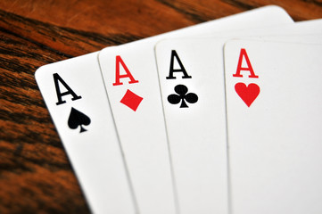 Four Aces - Playing Cards on Wooden Table