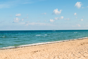 Fototapeta na wymiar Sand beach on the bright summer day