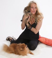 Blond young woman with her pomeranian dog