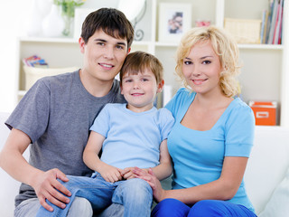 Happy family with son at home sitting on the sofa