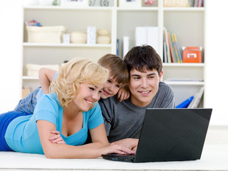 Happy family at home looking at laptop