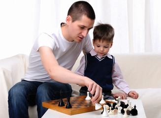 Dad and son playing chess