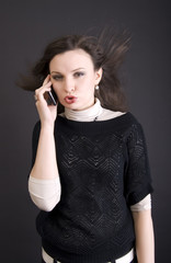 Fototapeta premium Portrait of a young girl speaking by the phone