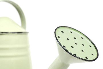 Detail of a green watering can, selective focus