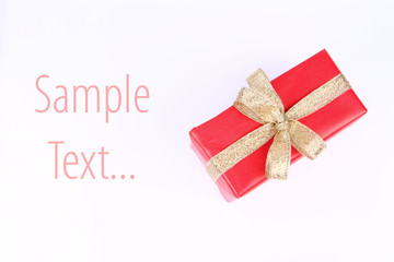 Gift in red wrapping with bow on white with text space