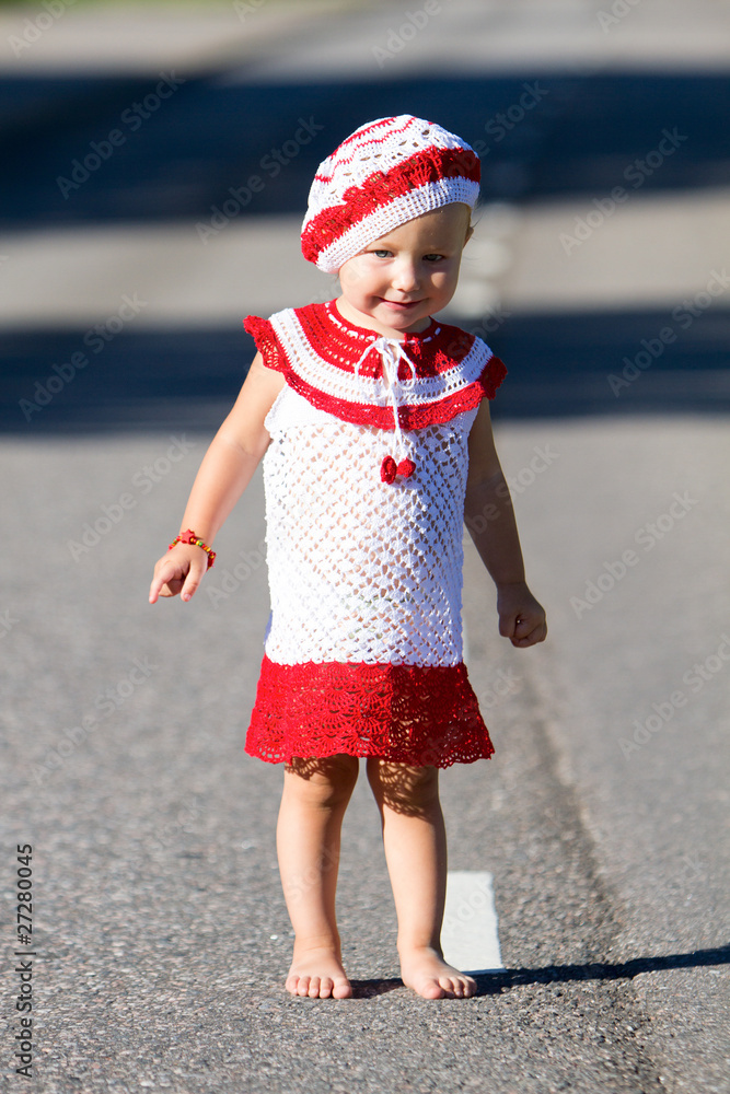 Poster Playful toddler girl on road