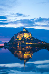 Mont Saint Michel abbaye reflected in the bay at sunset, France