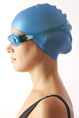 Close up portrait of woman with swim cap and swimming goggles
