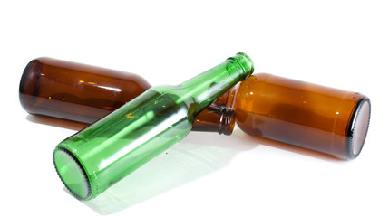 Three empty beer bottles in a pile on isolated background.