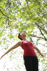 Woman spreading her arms at a park