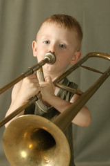 The boy costs on a scene and blows the trumpet © Alexander Onikiychuk