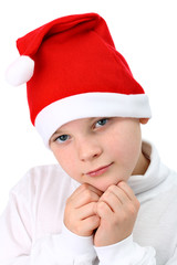 Small boy in Santa's red hat isolated on white