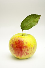 Apple with green leaf