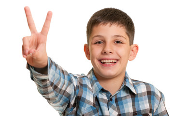 Happy boy showing a victory sign