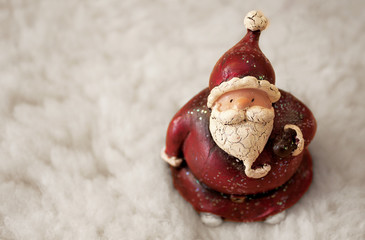 santa claus figurine on white snow background