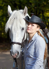 Obraz premium Young Lady hugging her horse