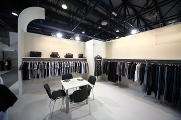 Exhibition hall with clothes on stands