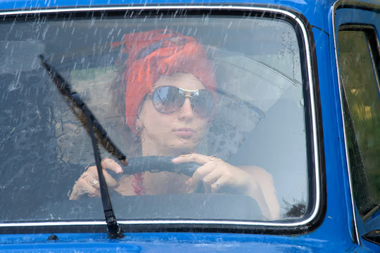 Vintage Girl In Car Under Rain