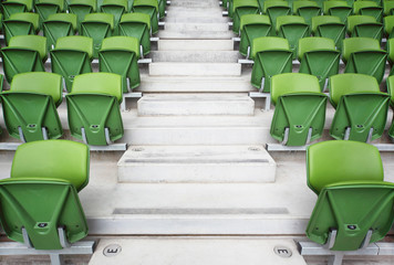 Naklejka premium Rows of folded seats in empty stadium. Focus on stairway